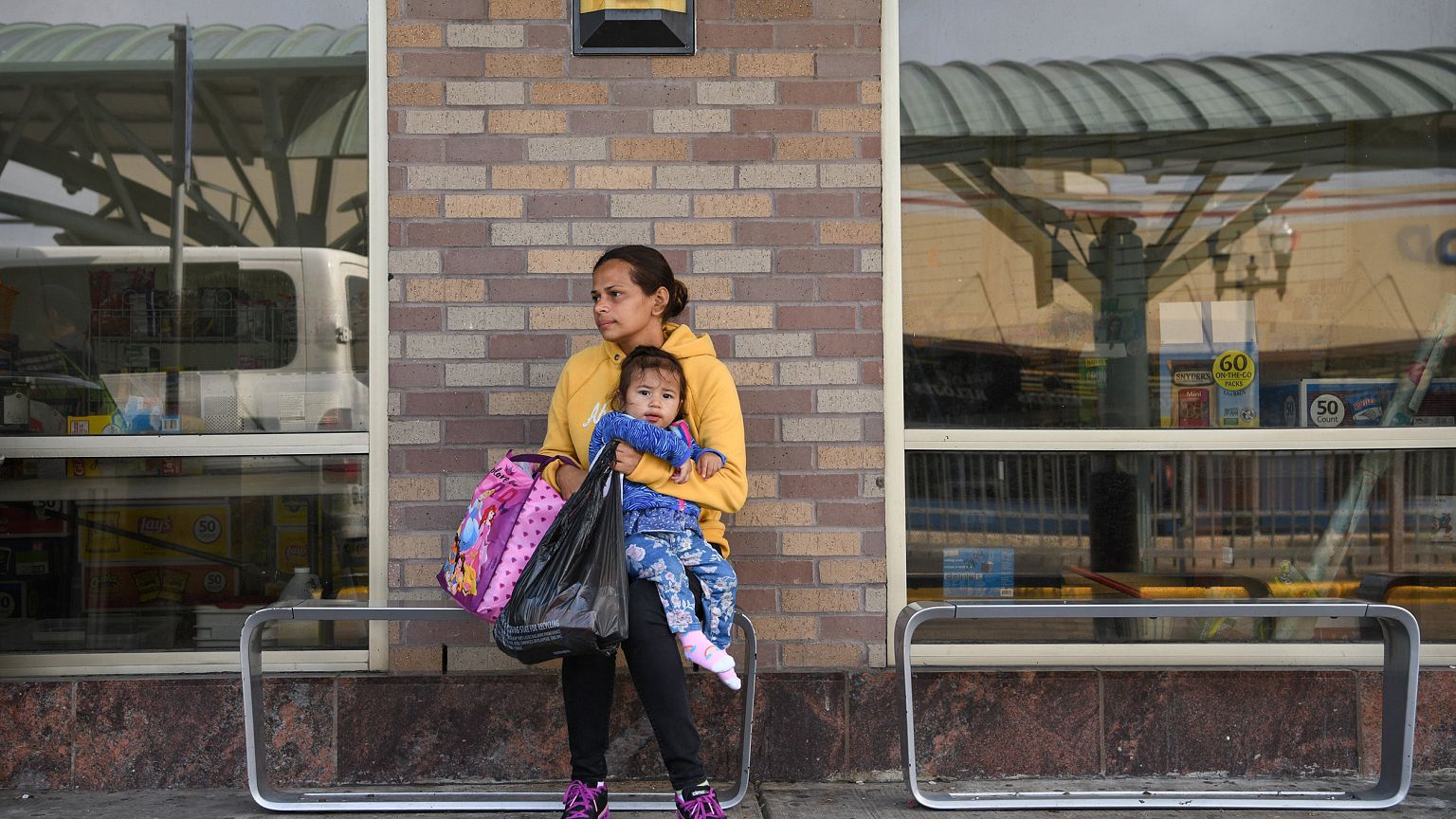 Image: Asylum seekers from Honduras recently released from detention sit at