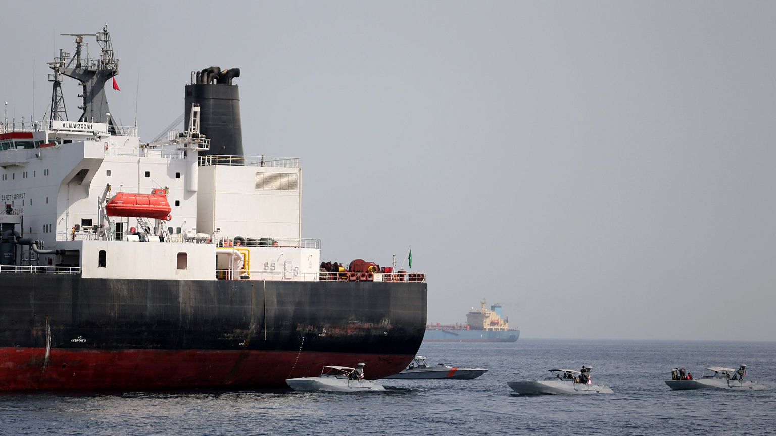 Image: UAE Navy boats are seen next to the Saudi tanker Al Marzoqah off the