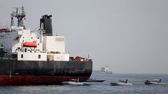 Image: UAE Navy boats are seen next to the Saudi tanker Al Marzoqah off the