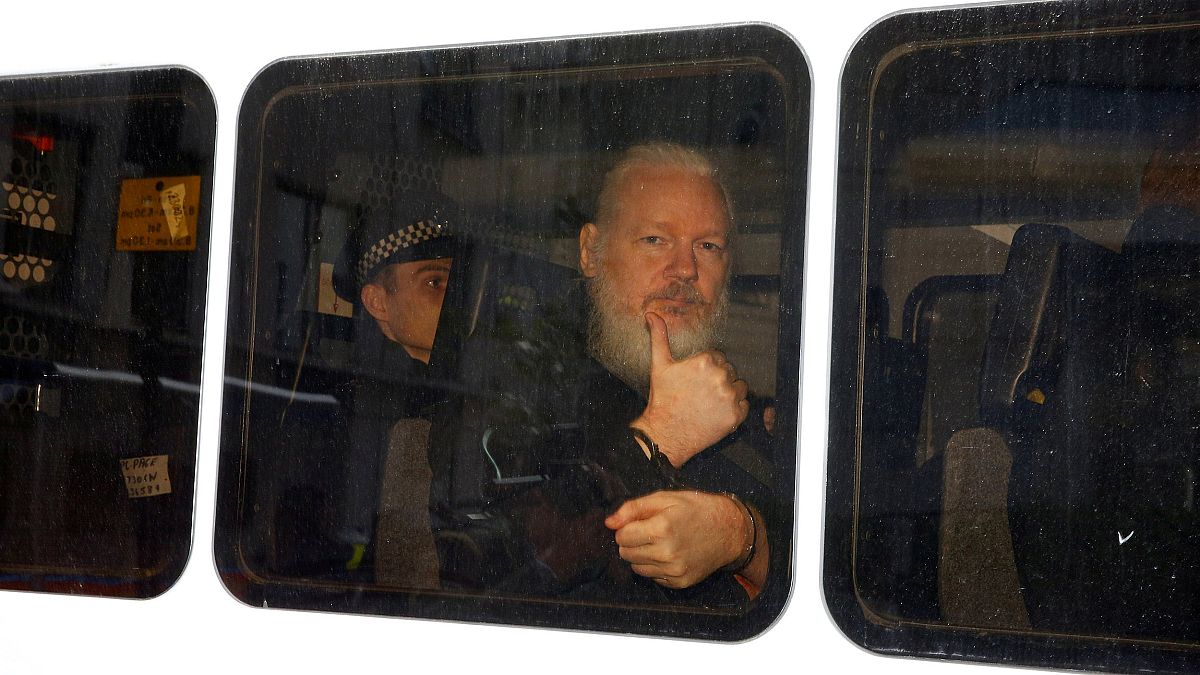 Image: WikiLeaks founder Julian Assange in a police van after was arrested 