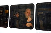 Image: WikiLeaks founder Julian Assange in a police van after was arrested