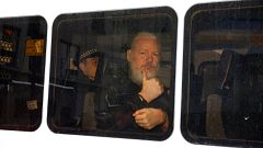 Image: WikiLeaks founder Julian Assange in a police van after was arrested 