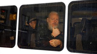 Image: WikiLeaks founder Julian Assange in a police van after was arrested