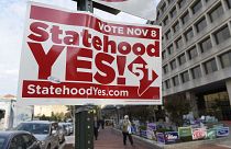 Image: Signs supporting DC statehood are on display outside an early voting