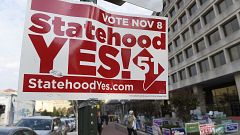 Image: Signs supporting DC statehood are on display outside an early voting