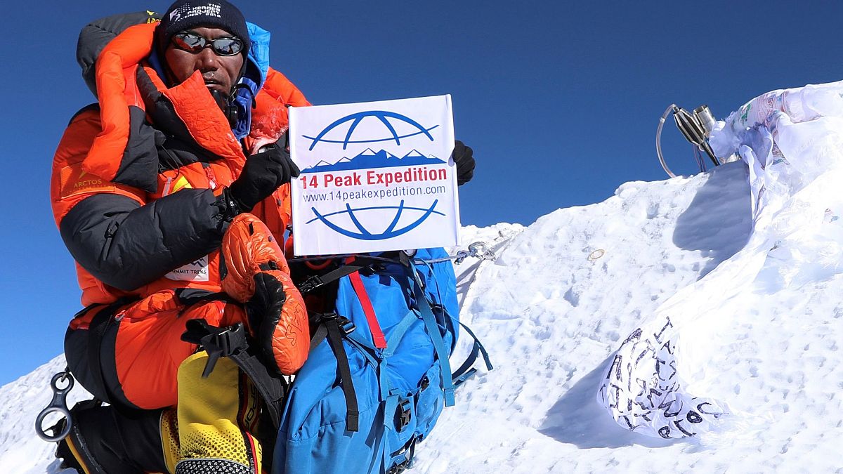 Image: Nepali mountaineer Kami Rita Sherpa posing at the top of Mount Evere