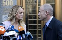 Image: Stormy Daniels looks her attorney, Michael Avenatti, after making a