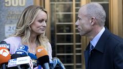 Image: Stormy Daniels looks her attorney, Michael Avenatti, after making a 