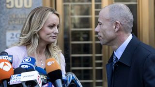 Image: Stormy Daniels looks her attorney, Michael Avenatti, after making a