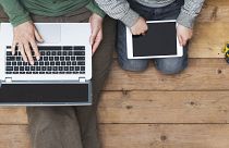 Image: mother and son using laptop and tablet pc