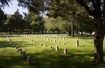 Image: A cemetery with headstones.
