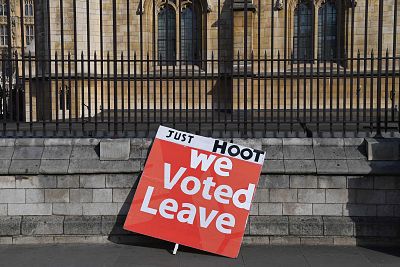 Placards supporting both sides of the Brexit debate line the sidewalks outside the Houses of Parliament in London.