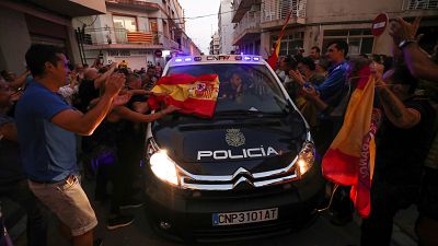 Pro-Spain protesters rally with police officers in Catalonia