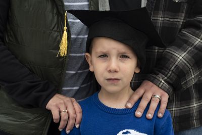 Owen Mathews, 5, after his preschool graduation. Owen\'s family is leaving the area and his father is looking forward to returning to a five-day schedule.