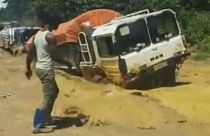 Watch: Aid trucks swarm across pools of mud