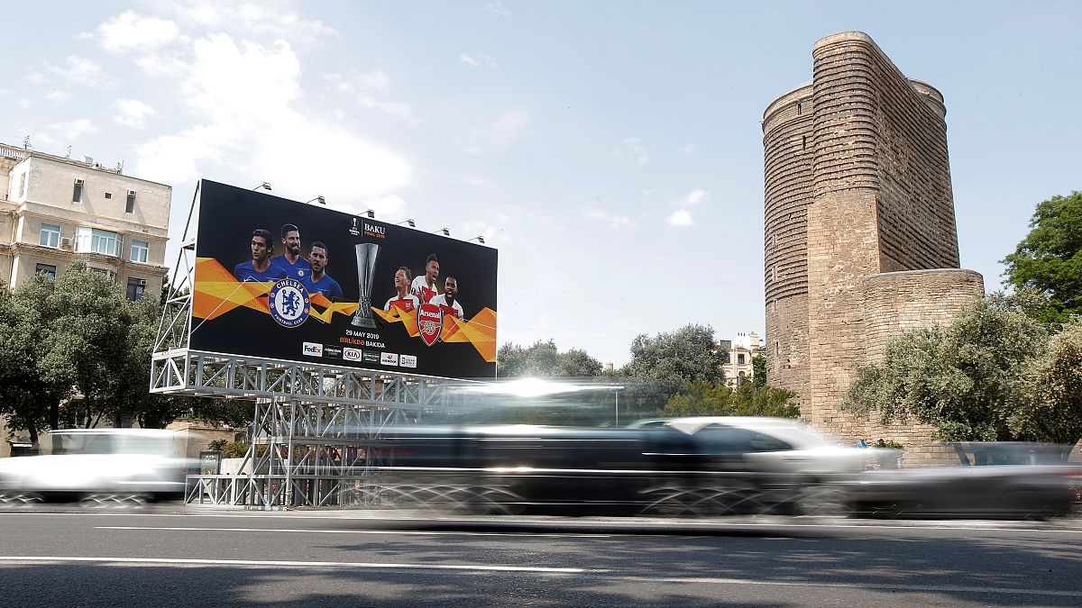 Image: A billboard next to The Maiden Tower in Baku, Azerbaijan