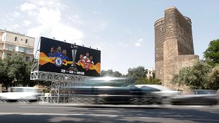 Image: A billboard next to The Maiden Tower in Baku, Azerbaijan