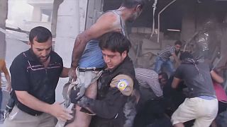 A man and boy were pulled from the rubble of a building after an airstrike in Idlib