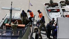 Image: A South Korean rescue team at the site of a ship accident, which kil