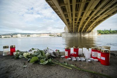 Candles and flowers are left under the Margaret Bridge in Budapest, Hungary, near where a tour boat sank.