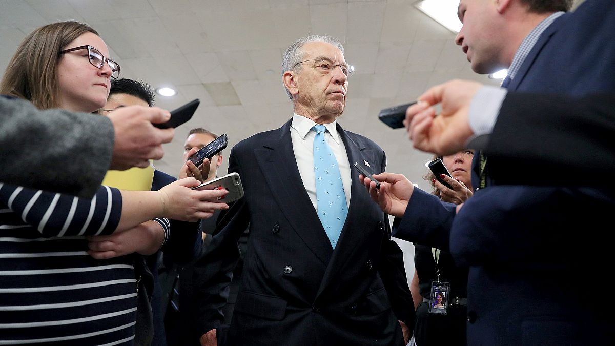 Image: U.S. Senator Grassley speaks to reporters on his way from the Senate