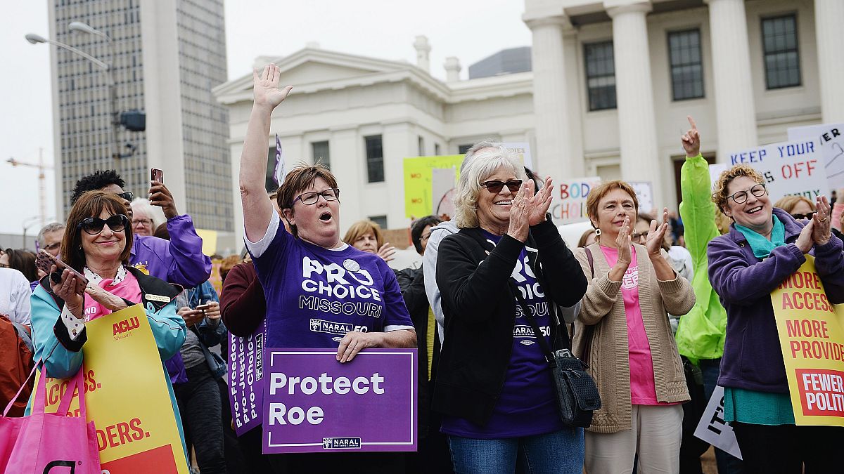 Image: Women cheer during a protest rally over recent restrictive abortion 