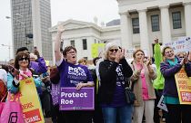 Image: Women cheer during a protest rally over recent restrictive abortion