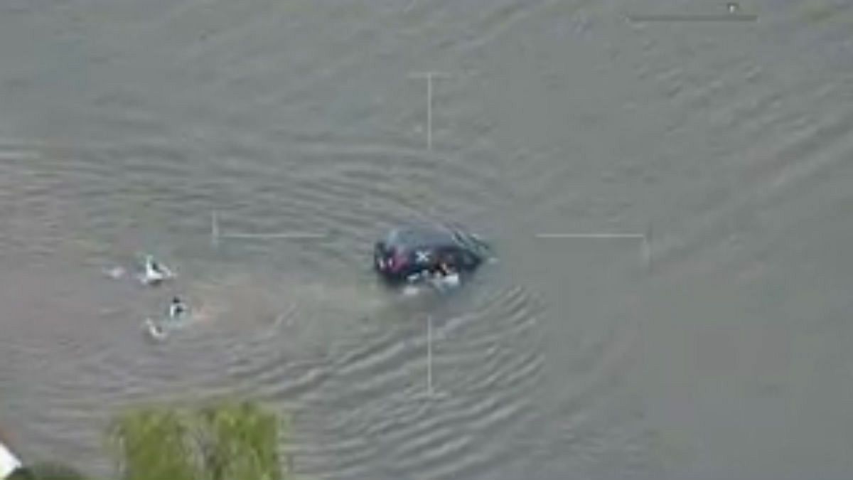 Watch: Police swim out to save woman from sinking car
