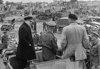 British Prime minister Winston Churchill, Sir Miles Dempsey, British second Army commandant, and British Field Marshal Bernard Montgomery visit the destroyed city of Caen, after Allied forces stormed the Normandy beaches on D-Day.