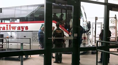 Border patrol agents speak with local law enforcement outside the Syracuse bus station on May 9, 2019.