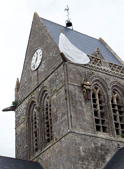 Church in Sainte-mere-eglise, where a fake parachutist hangs on the bell tower in memory of John Steele, in Normandy, France on June 4, 2019.