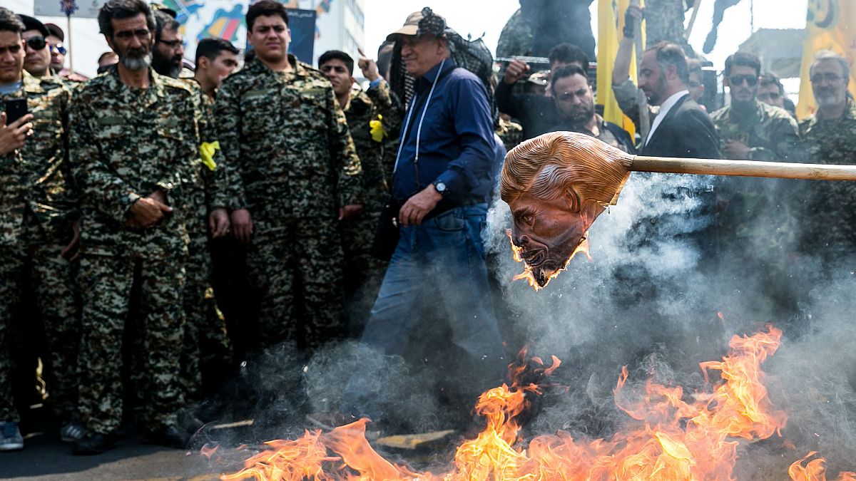 Image: Iranians burn a mask of  President Donald Trump during a protest mar