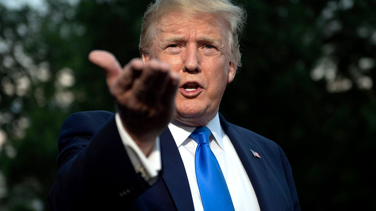Image: President Donald Trump speaks with reporters as he leaves the White 