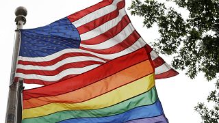 Image: The rainbow flag flies beneath the American flag