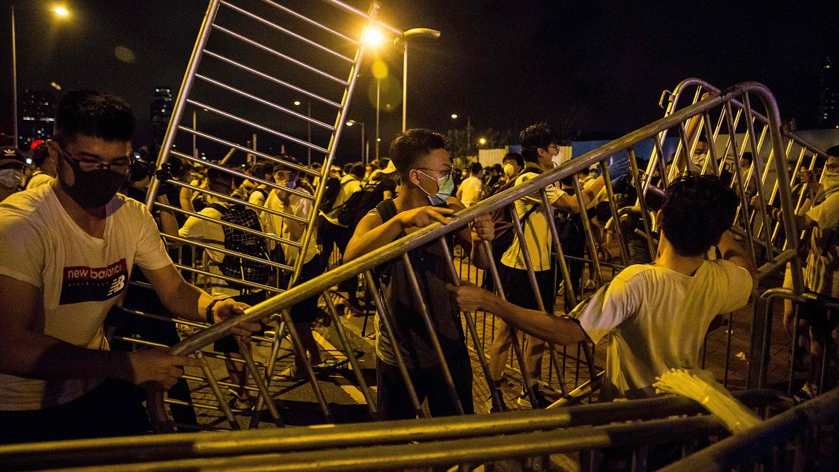 Image: Protesters block roads during clashes with police in Hong Kong
