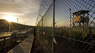 Image: The sun rises over Camp Delta detention compound at Guantanamo Bay