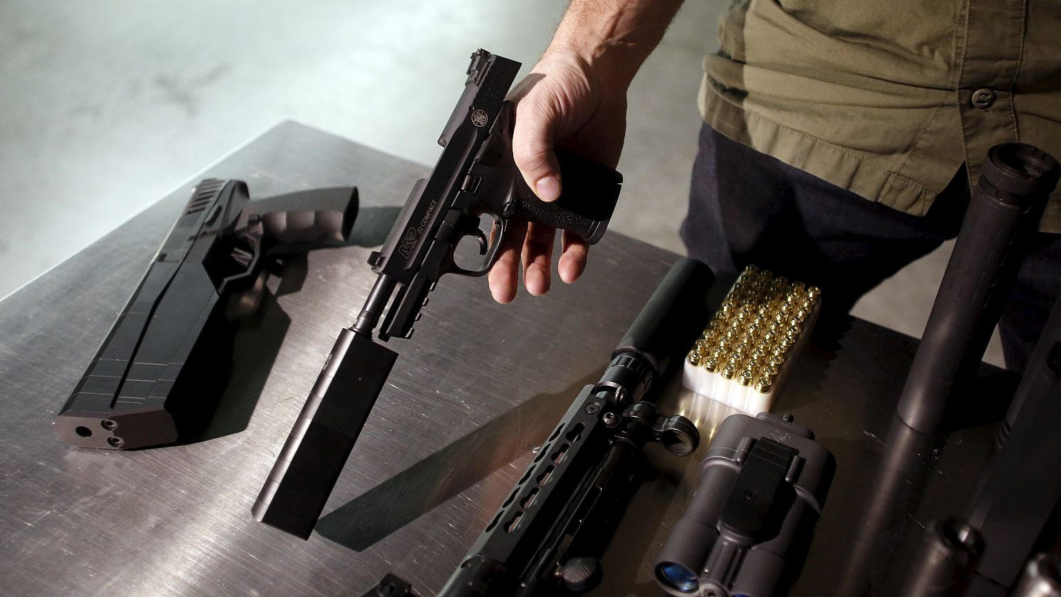 Image: SilencerCo CEO Joshua Waldron shows guns with suppressors in West Va