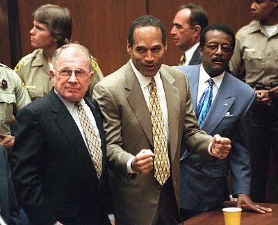 O.J. Simpson, with his attorneys F. Lee Bailey, left, and Johnnie L. Cochran, right, as the verdict is read finding Simpson not guilty of killing his Nicole Brown-Simpson and Ron Goldman in Los Angeles County Superior Court in October 1995. 