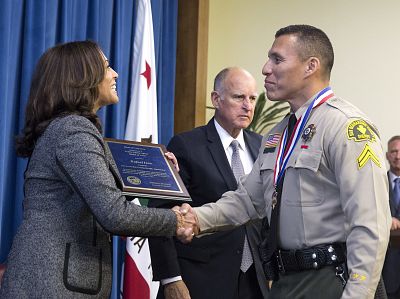 San Bernardino Sheriff\'s Corporal Rafael Ixco is congratulated by Attorney General Kamala Harris, after Gov. Jerry Brown, center, presented him with the Governor\'s Public Safety Officer Medal of Valor on Sept. 12, 2016, in Sacramento, California.