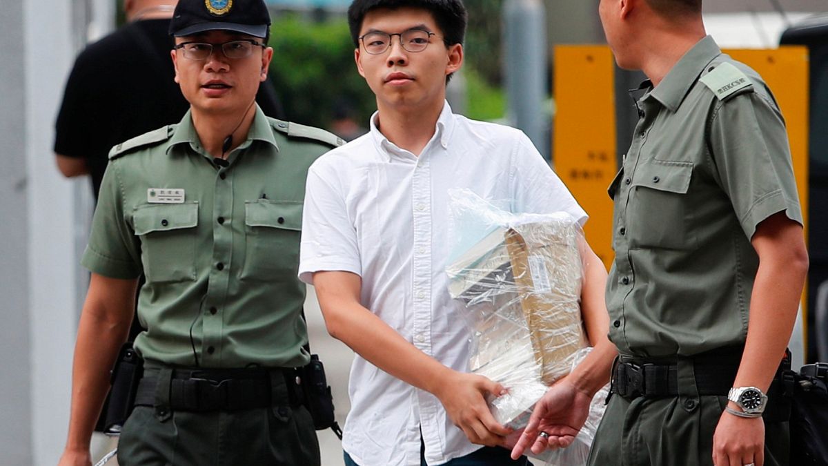 Image: Former student leader Joshua Wong walks out from prison after being 