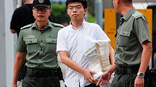 Image: Former student leader Joshua Wong walks out from prison after being 