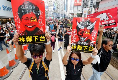 Protesters hold placards as they attend a demonstration demanding Hong Kong\'s leaders to step down and withdraw the extradition bill, in Hong Kong, China.