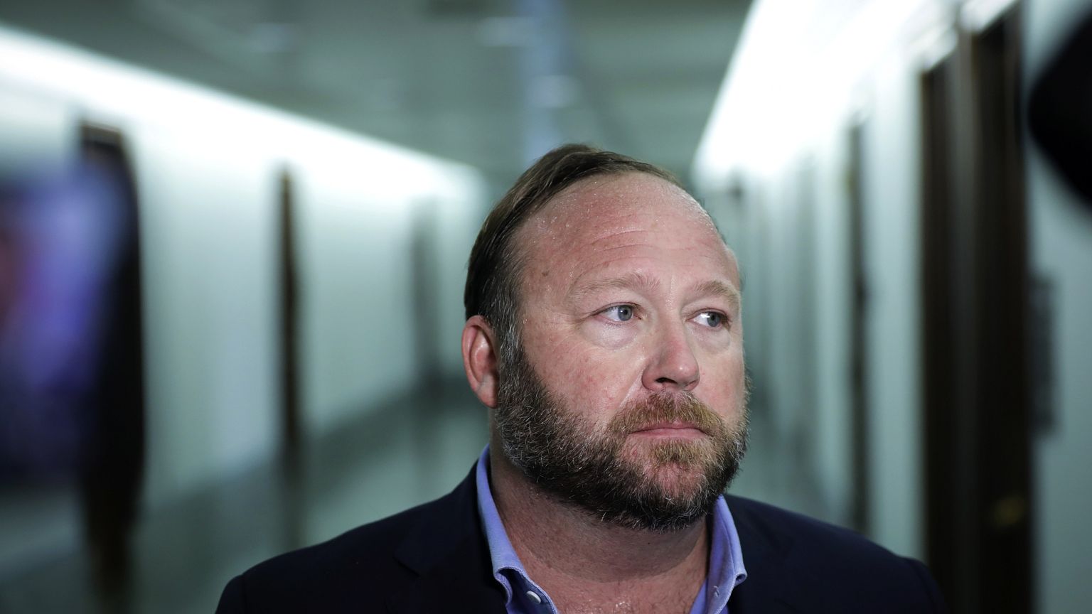 Image: Alex Jones speaks to reporters outside of a Senate Intelligence Comm