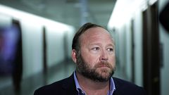 Image: Alex Jones speaks to reporters outside of a Senate Intelligence Comm