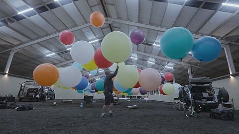 Man flies over South Africa using balloons and a camping chair