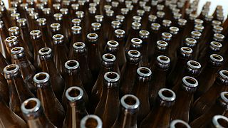 Beer today… truck smash leaves 30,000 bottles strewn across road