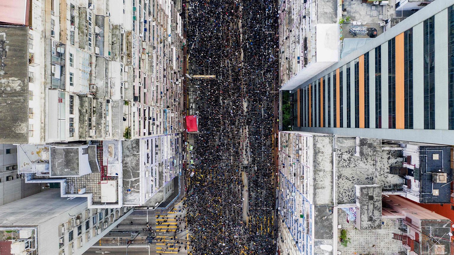 Image: Thousands of protesters marching through the street as they take par