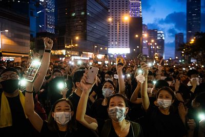 Protesters shine lights from their mobile phones during one of the demonstrations on June 16.
