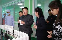 Rare public outing for Kim's wife on factory tour