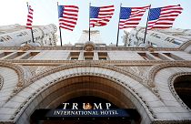 Image: Flags fly above the entrance to the new Trump International Hotel on